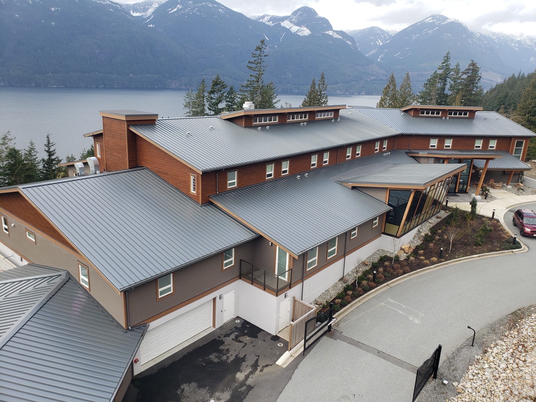 A large building with completed cladding and a water view
