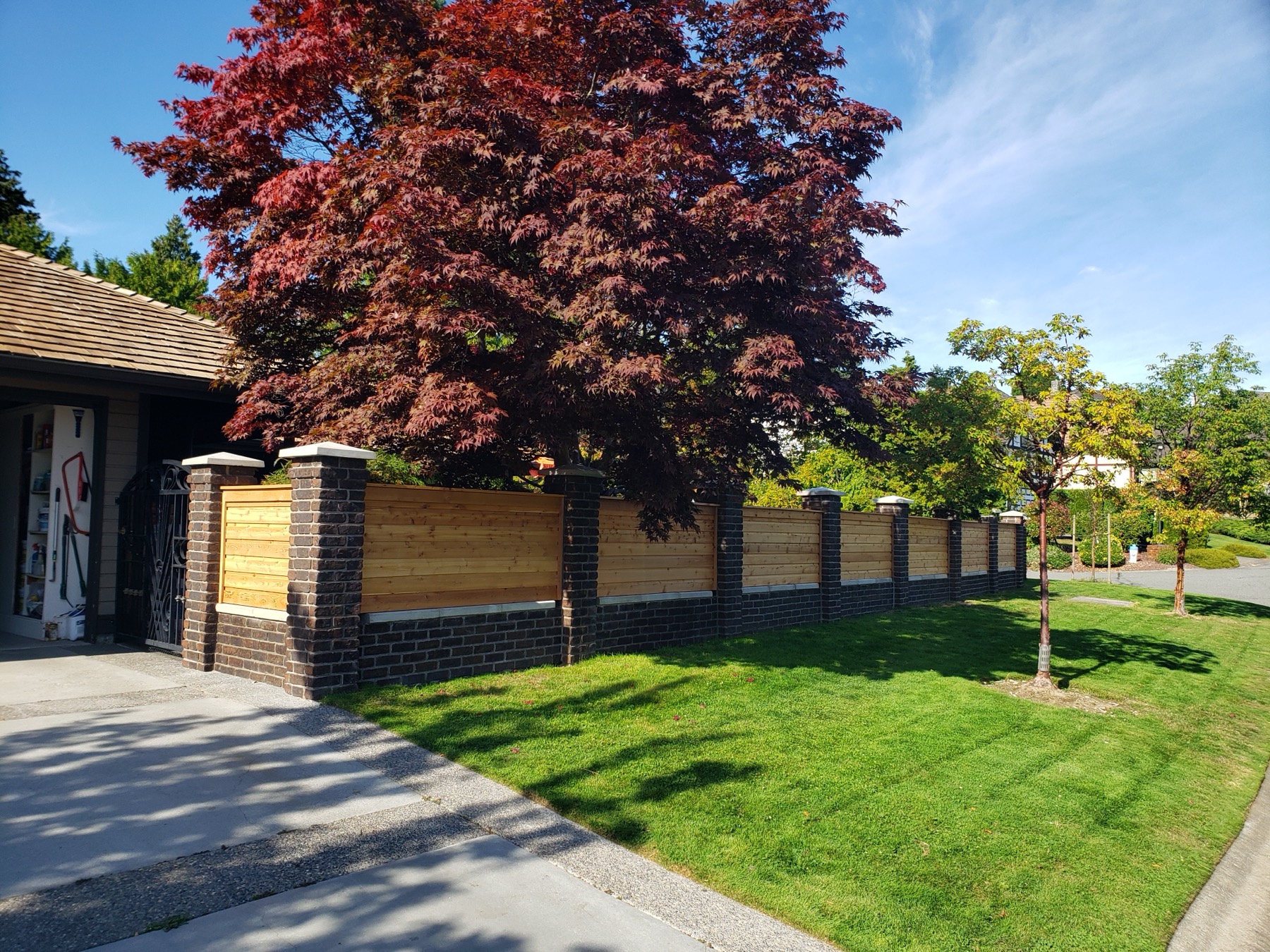 A dark timber screen and fence
