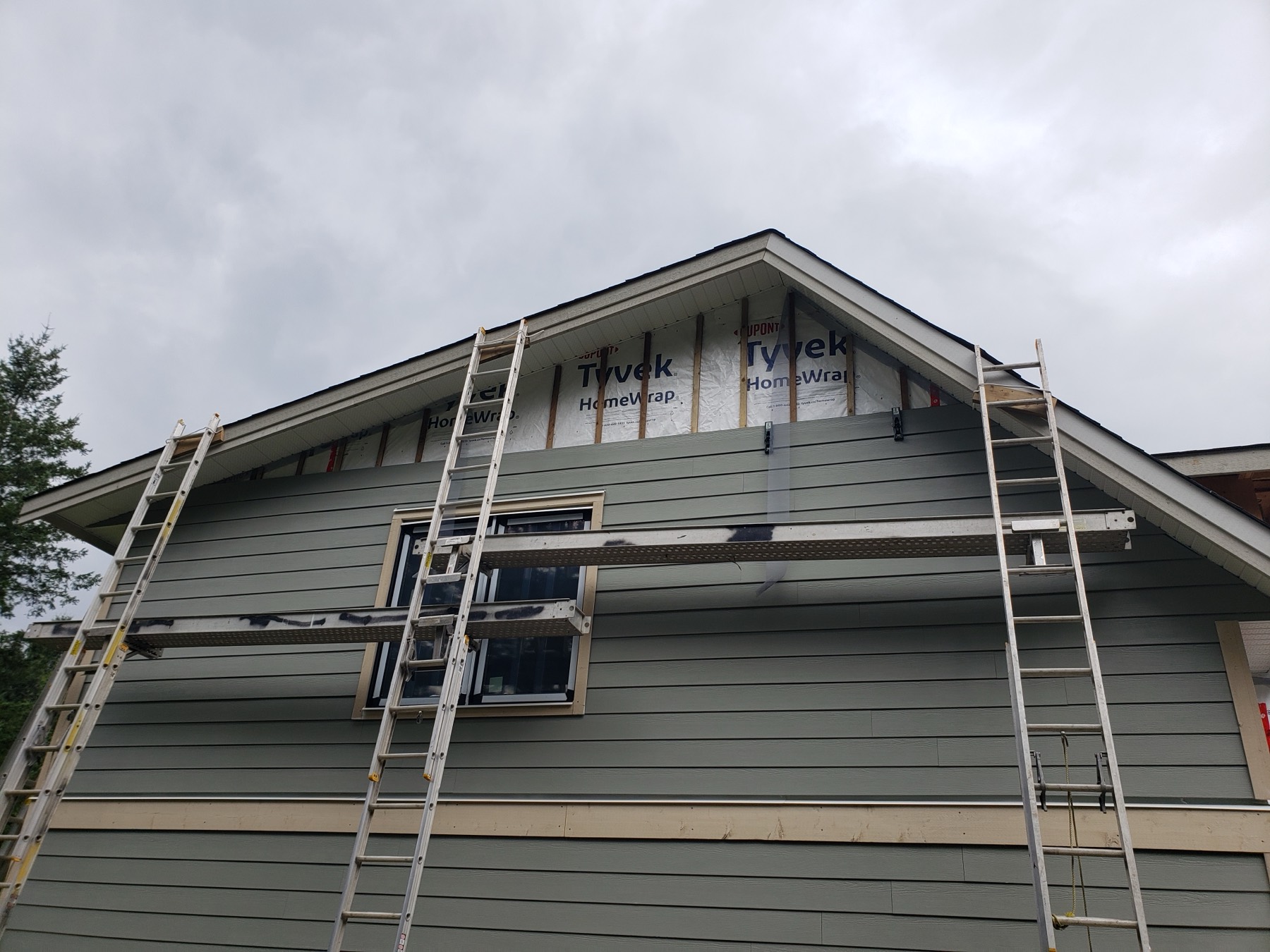 A gable being clad from ladders